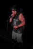 An image of Terracons member 2essentialz wearing a hat, on stage with microphone in hand.